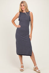 woman wearing a navy and white striped sleeveless midi dress with tie shoulder details and a side slit