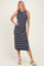 woman wearing a navy and white striped sleeveless midi dress with tie shoulder details and a side slit