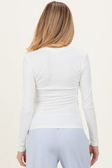 maternity wear long sleeve white top with back ruched detailing and paired with light blue pants