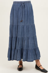 woman wearing a blue tiered denim maternity skirt with an elastic waistband and drawstring
