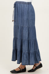 woman wearing a denim tiered maxi skirt, featuring an elastic waistband and a flowy silhouette, maternity wear