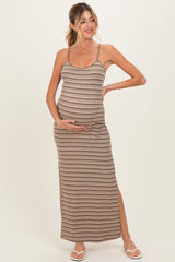 woman wearing a brown striped maternity maxi dress and holding her baby bump
