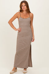 woman wearing a brown and beige striped maxi dress with a side slit and thin straps