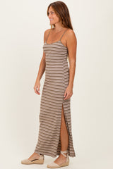 woman wearing a brown striped maxi dress with side slits and spaghetti straps