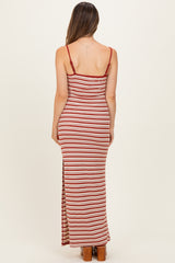 woman wearing a red and white striped maternity maxi dress with spaghetti straps and a side slit