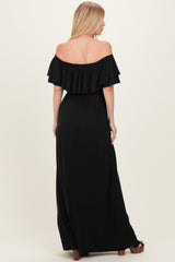 woman wearing a black off-the-shoulder maxi dress with ruffle detailing and a flattering waistline