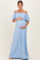 woman wearing a light blue off-the-shoulder maternity maxi dress and holding her baby bump