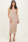 woman wearing a fitted beige ribbed midi dress with a sweetheart neckline and side slit