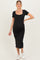 woman wearing a black ribbed maternity dress with short sleeves and a fitted silhouette, showing her baby bump