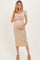 woman wearing a beige short sleeve maternity dress and holding her baby bump