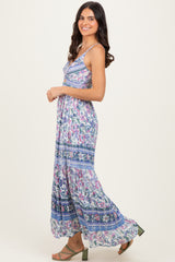 woman wearing a floral print maxi dress with spaghetti straps and a flowing silhouette