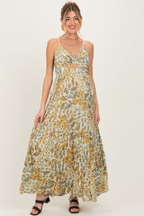 woman wearing a floral print maternity maxi dress with a knotted front detail and a visible baby bump