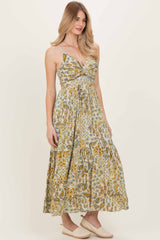 woman wearing a floral maxi dress with a sweetheart neckline and tiered skirt, styled with espadrilles