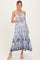 woman wearing a blue and white floral maternity maxi dress and holding her baby bump