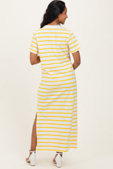 woman wearing a white and yellow striped maternity maxi dress with a split at the side