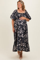 woman wearing a floral print navy blue maternity maxi dress with puff sleeves and a visible baby bump