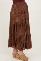 maternity wear rust colored maxi skirt with floral print and tiered design, model wearing a burgundy top and clogs
