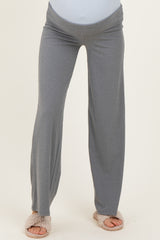woman wearing grey maternity pants with a comfortable waistband and relaxed fit, showing her baby bump