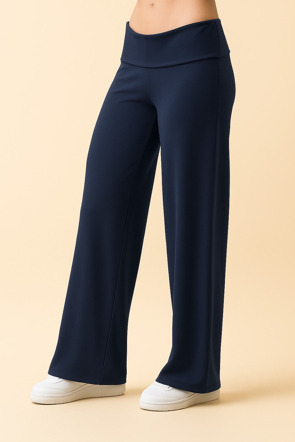 woman wearing navy blue wide-leg pants with a high waistband and white sneakers