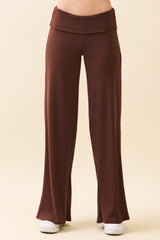 woman wearing brown flared lounge pants with a high waistband and side pockets