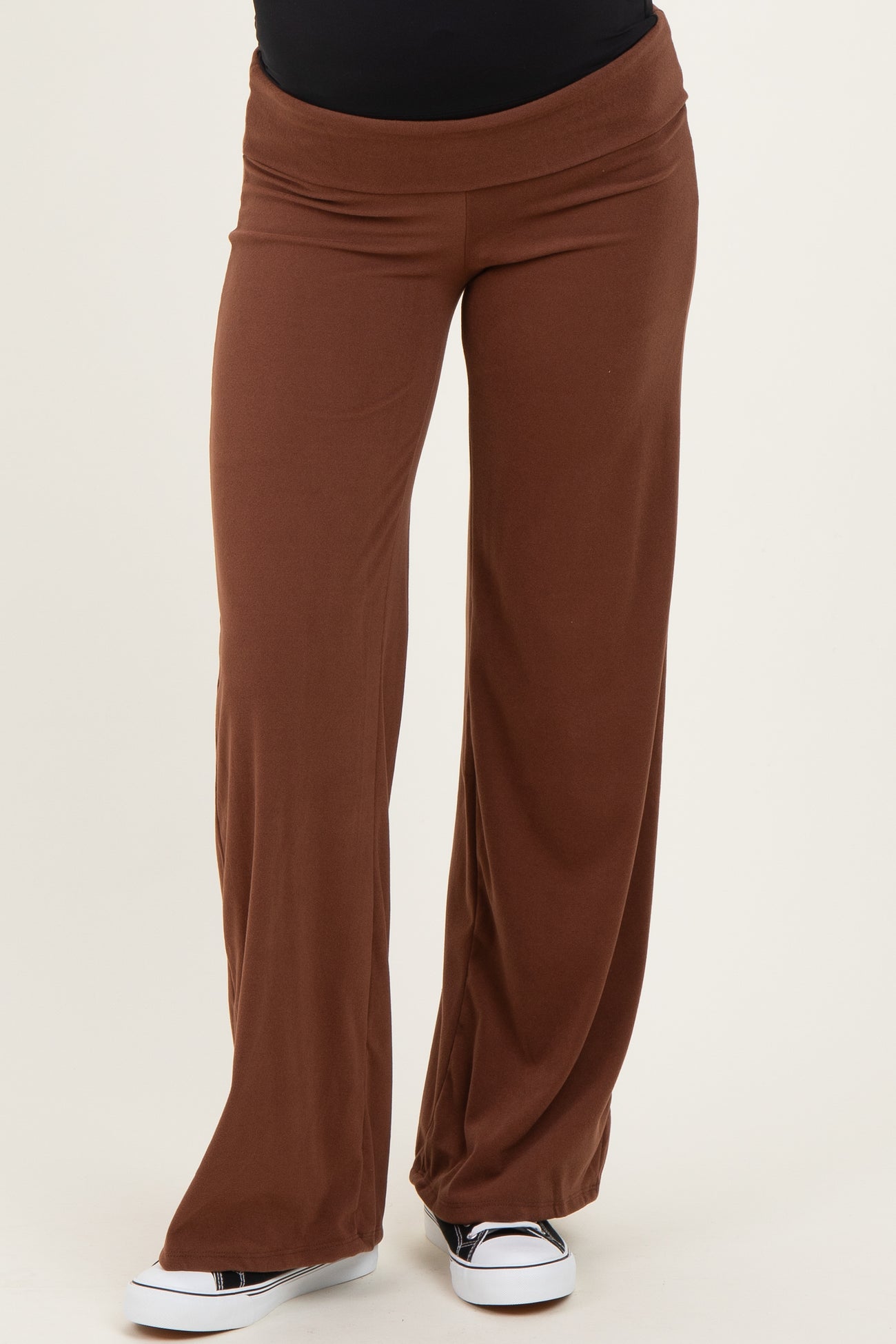 maternity wear brown wide-leg pants with a stretchy waistband, styled with a black top and casual white sneakers