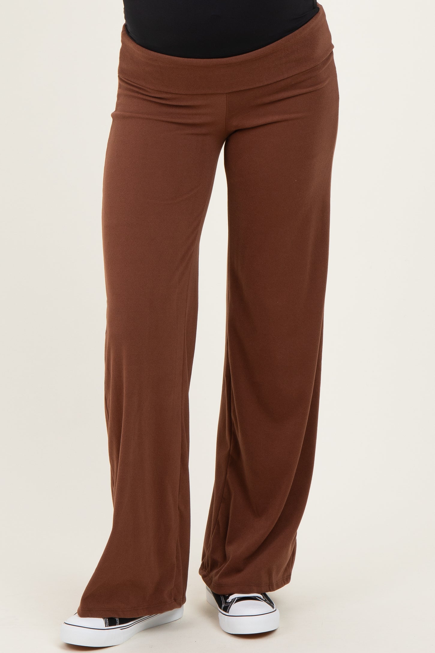 maternity wear brown wide-leg pants with a stretchy waistband, styled with a black top and casual white sneakers