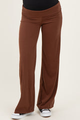 maternity wear brown wide-leg pants with a stretchy waistband, styled with a black top and casual white sneakers
