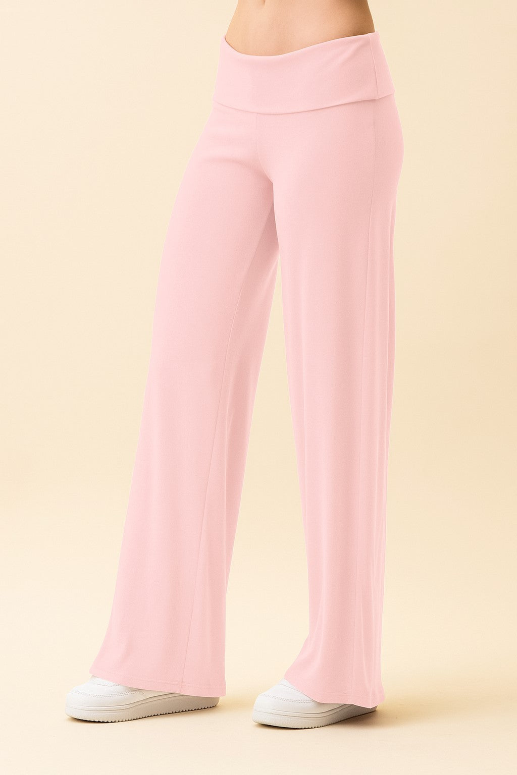 woman wearing light pink wide-leg lounge pants with an elastic waistband