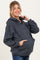 woman wearing a dark gray maternity hoodie with a front pocket and a relaxed fit, holding the hood while smiling