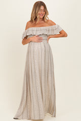 woman wearing a loose fitting off-the-shoulder striped maternity maxi dress and holding her baby bump