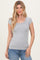 woman wearing a gray ribbed short sleeve top with a square neckline and standing against a neutral background