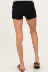 woman wearing black maternity shorts, showing the back view with a fitted waistband