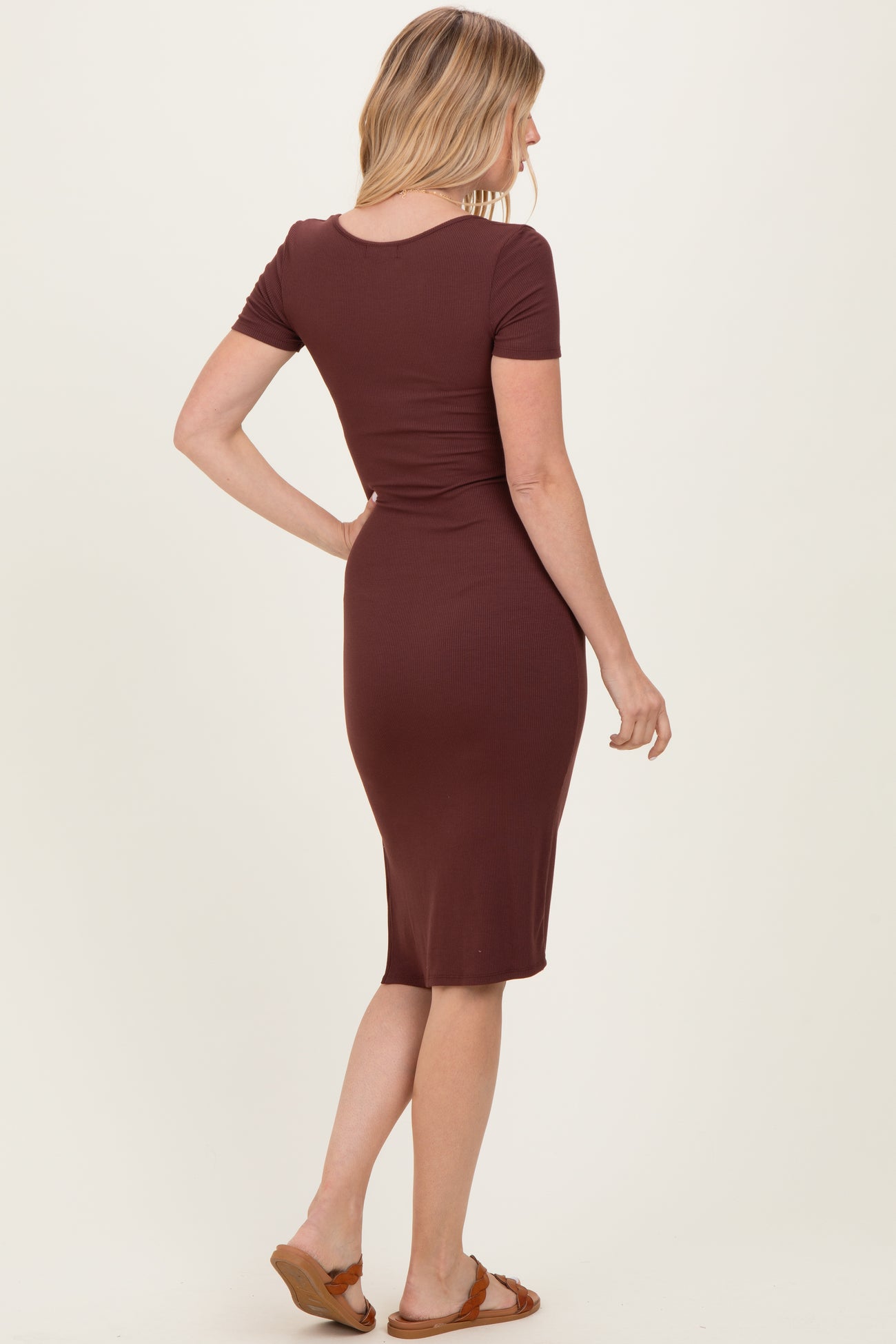 woman wearing a maroon ribbed midi dress with short sleeves, viewed from the back