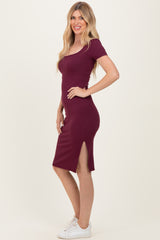woman wearing a burgundy ribbed midi dress with short sleeves and side slits