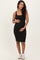 woman wearing a black ribbed maternity dress and holding her baby bump