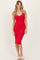 woman wearing a fitted red ribbed midi dress with a deep v-neckline and no sleeves