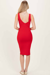 woman wearing a fitted red ribbed midi dress with a deep v-back and curves accentuated from behind