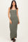 woman wearing a dark green ribbed maxi dress with a scoop neckline and button accents, styled with black sandals