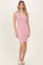 woman wearing a fitted light pink ribbed tank dress standing with hands at her sides