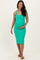 woman wearing a green form-fitting maternity dress and holding her baby bump