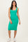 woman wearing a fitted green midi dress with square neckline and white sneakers