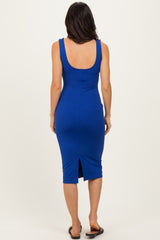 woman wearing a fitted royal blue midi dress with a scoop back and a slit at the hem