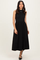 woman wearing a black sleeveless ribbed maxi dress with a fitted bodice and full skirt