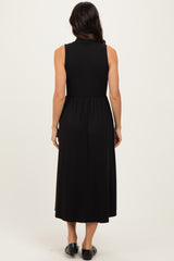 woman wearing a sleeveless black midi dress with a fitted bodice and flared skirt seen from the back
