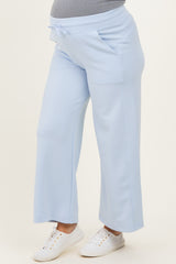maternity wear light blue wide-leg pants with front pockets, worn by a model highlighting her baby bump