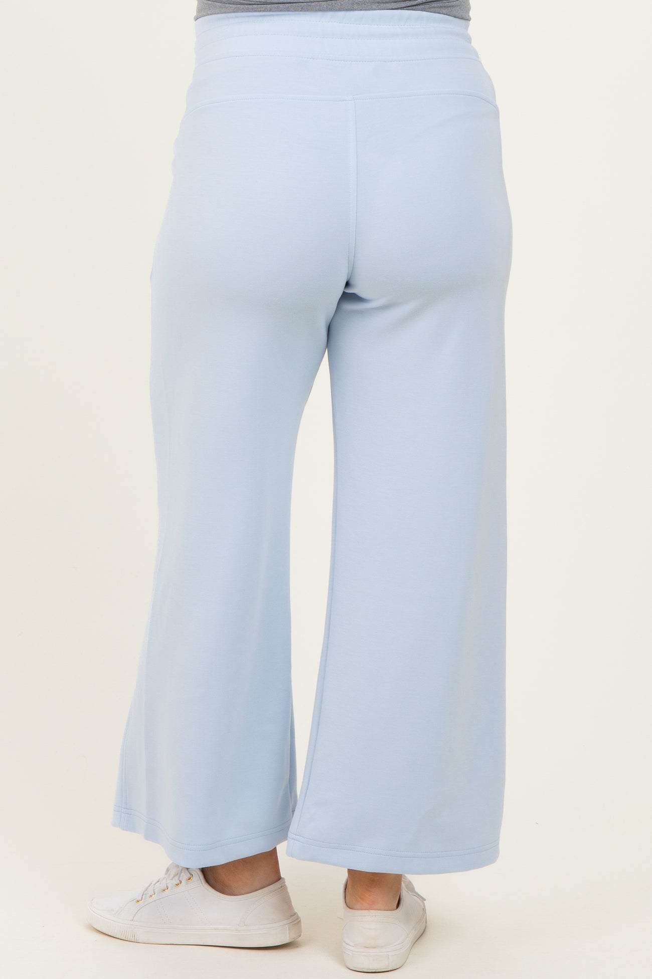 woman wearing light blue maternity wide-leg pants viewed from the back