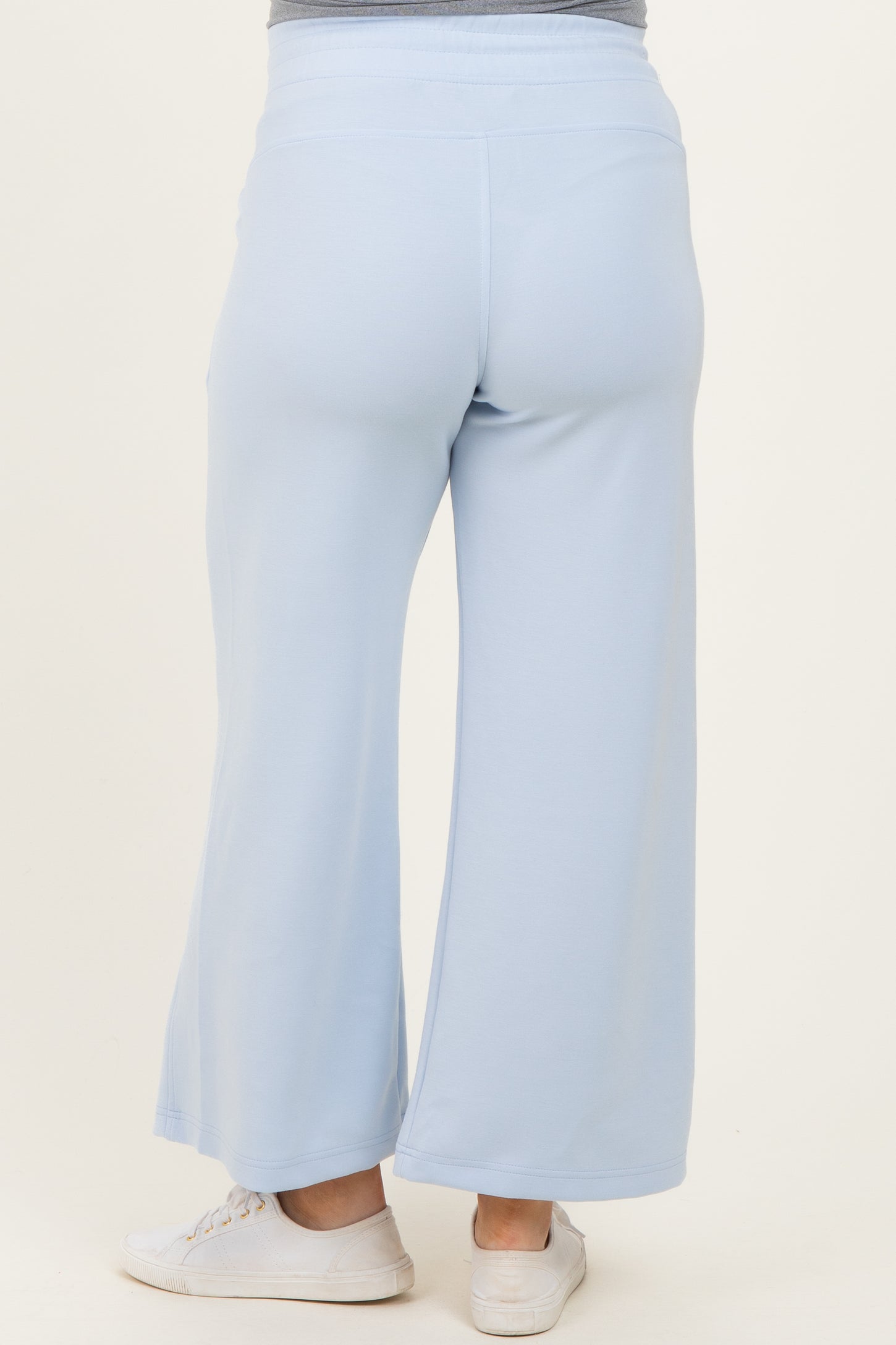 woman wearing light blue maternity wide-leg pants viewed from the back