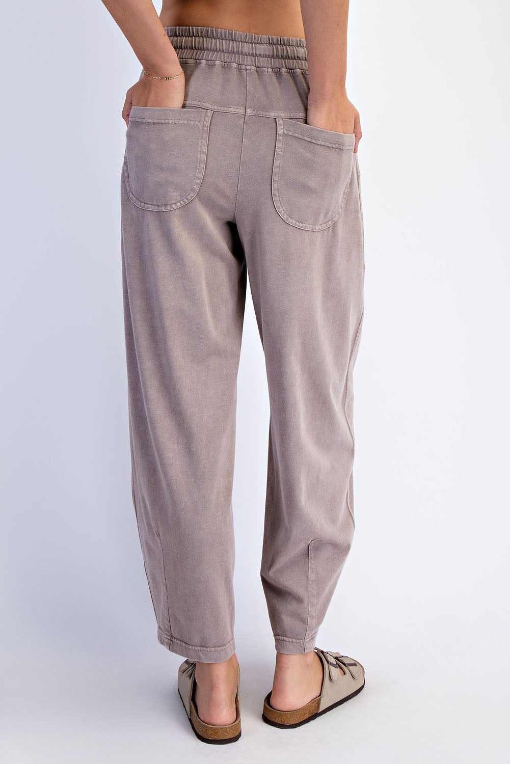 woman wearing light brown relaxed-fit pants with an elastic waistband and two back pockets