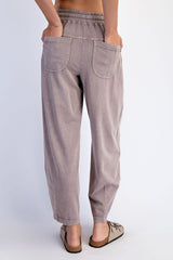 woman wearing light brown relaxed-fit pants with an elastic waistband and two back pockets