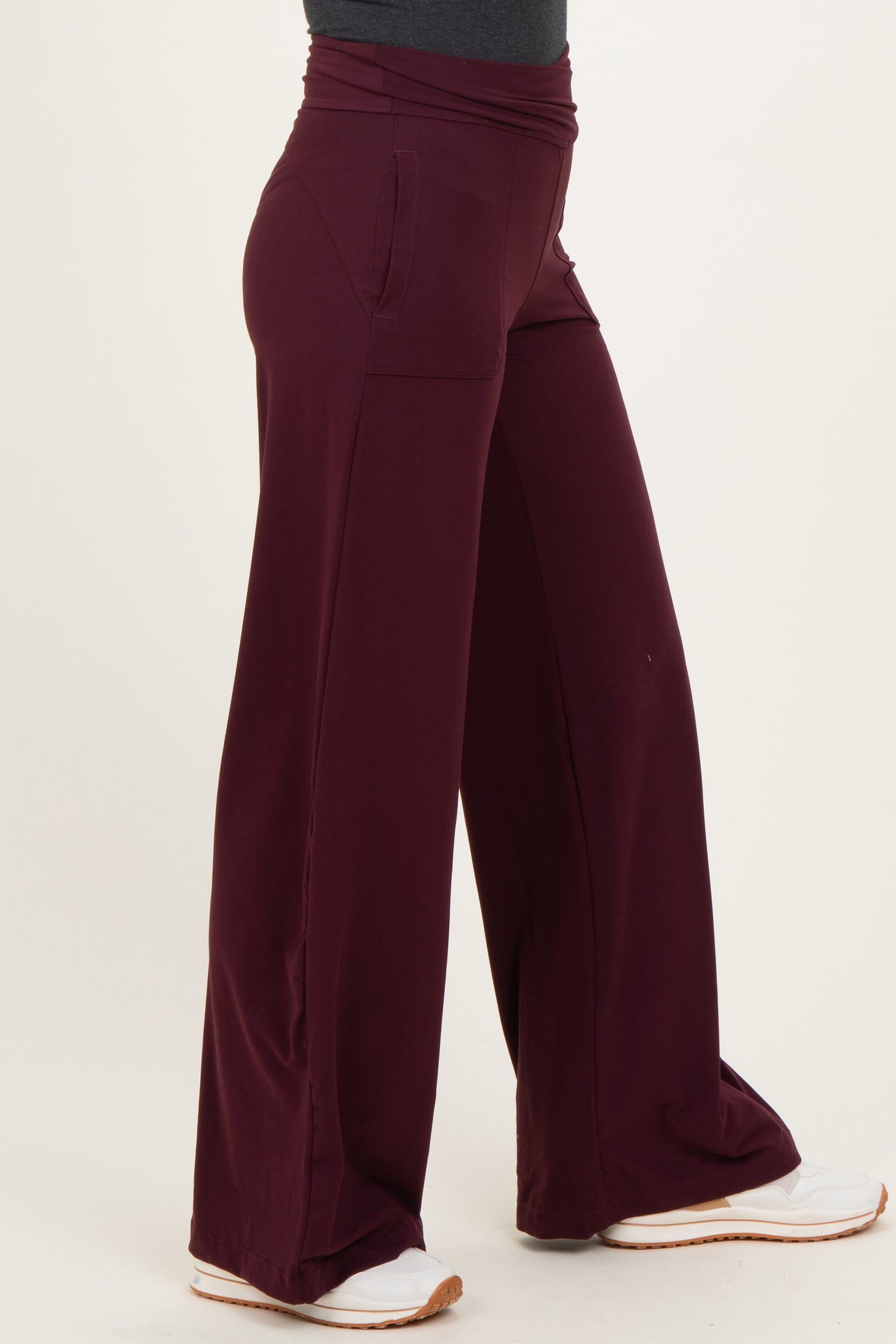 woman wearing burgundy wide-leg lounge pants with side pockets
